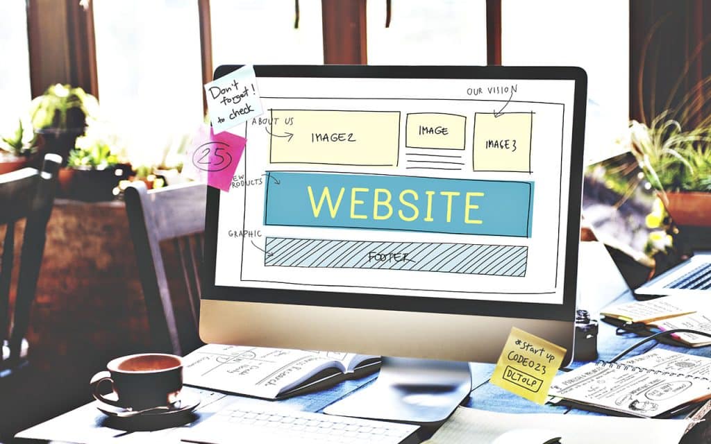 Web design project displayed on a computer screen with sketches and notes