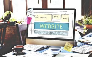 Web design project displayed on a computer screen with sketches and notes