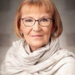 Melanie Rowan-Bonnell a therapist and an elderly woman with glasses wearing a light scarf against a grey background