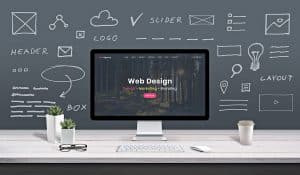 Web design concept with a desktop in front of a chalkboard background