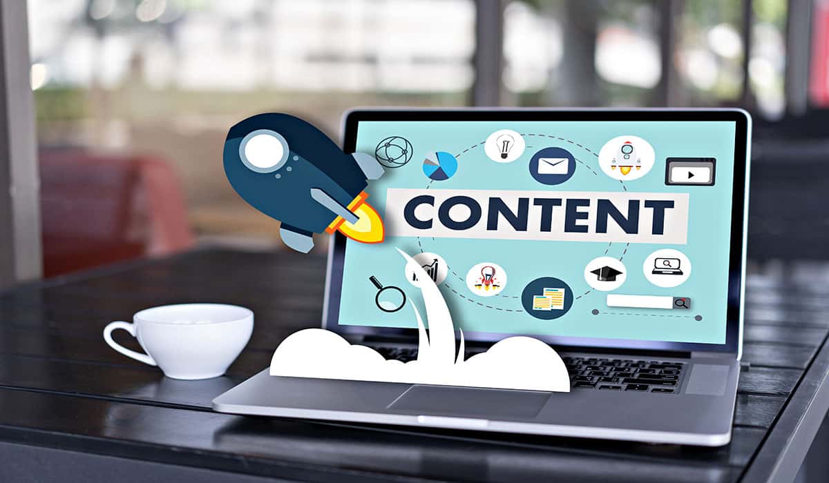 Digital marketing content strategy with rocket and icons on laptop