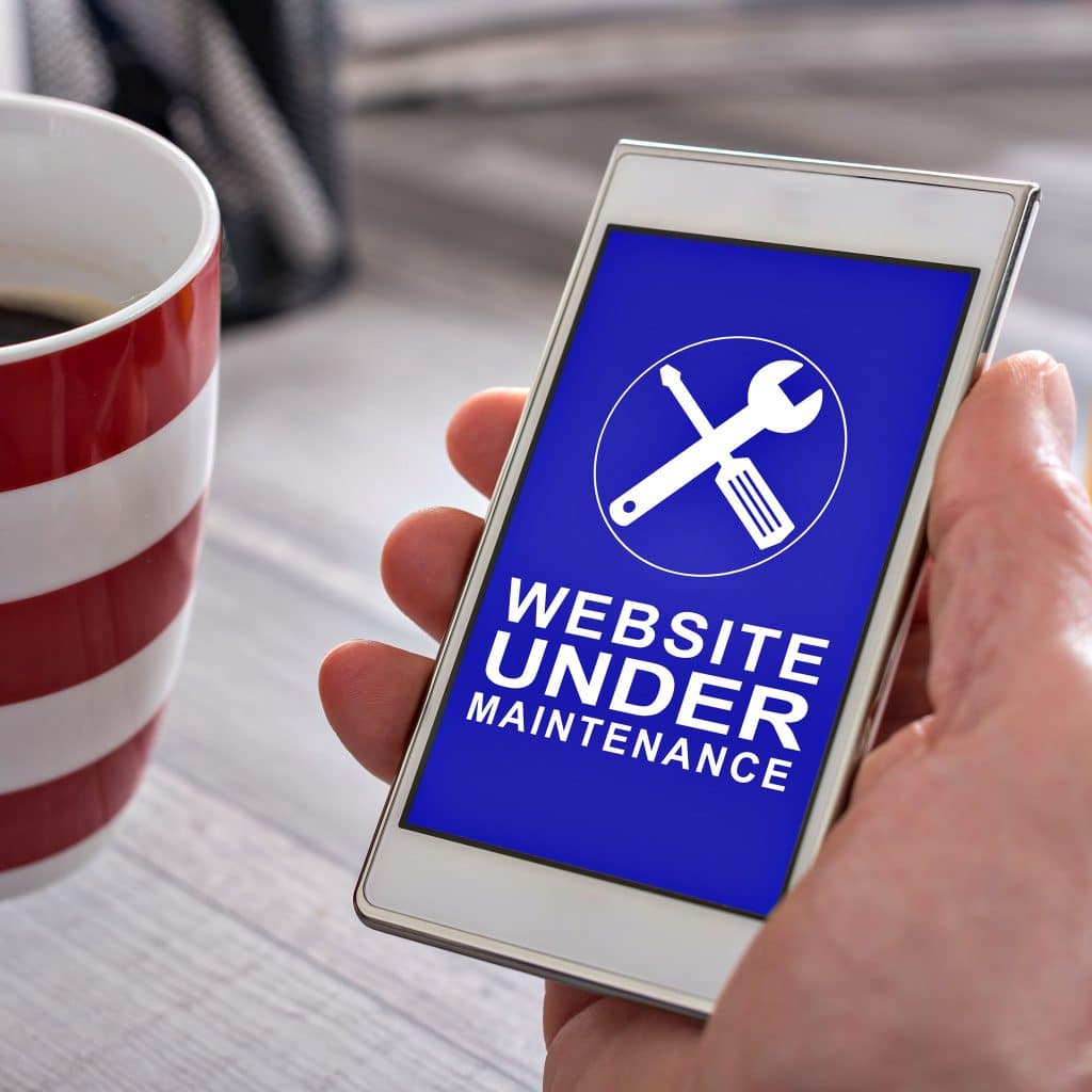 Smartphone displaying a 'Website Under Maintenance' alert on a blue screen
