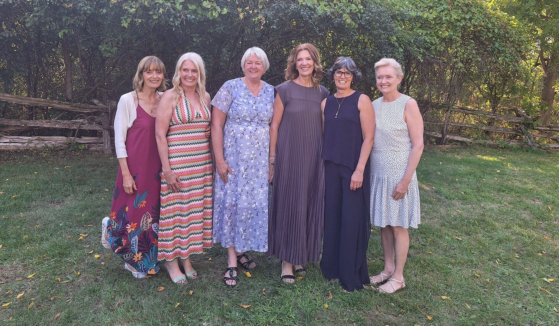 Group of six Martin women standing outdoors in summer dresses