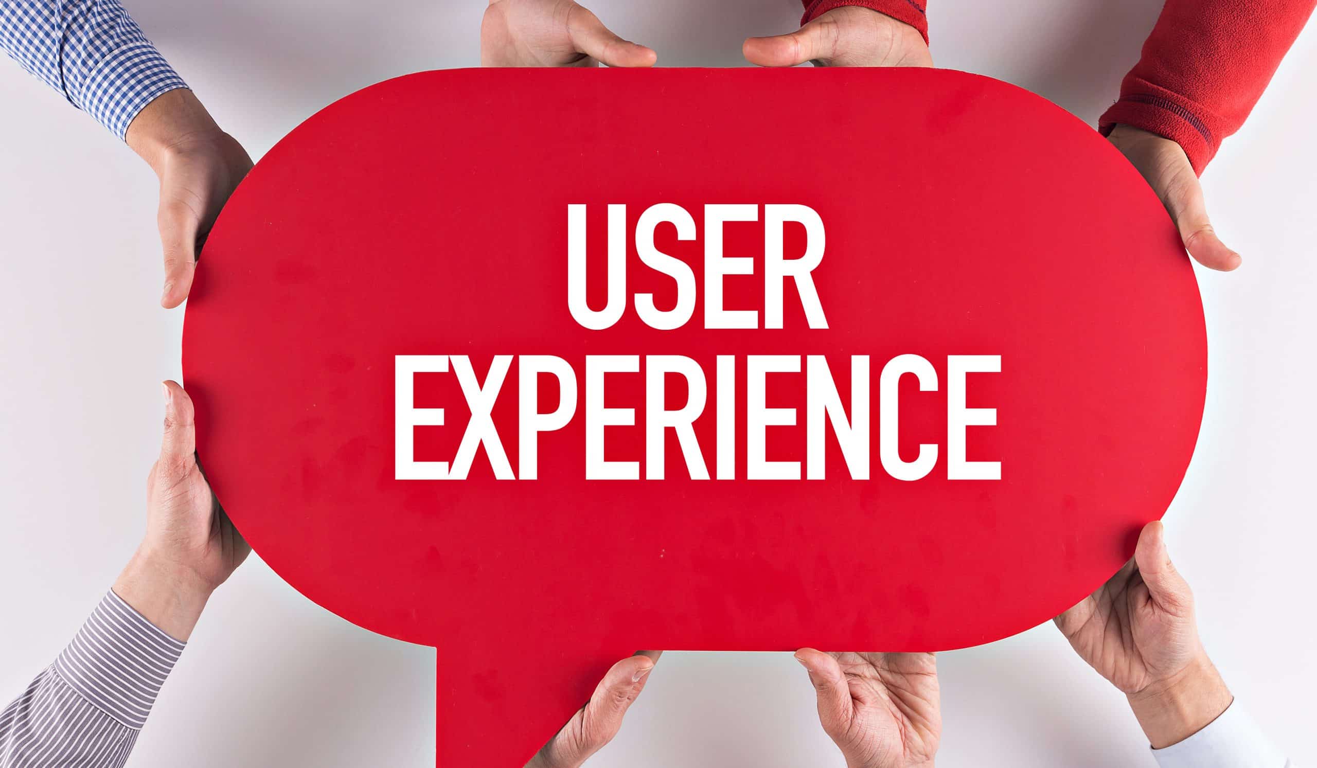 Hands holding red sign with User Experience text