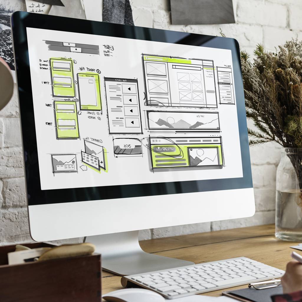 Computer screen displaying website design wireframes