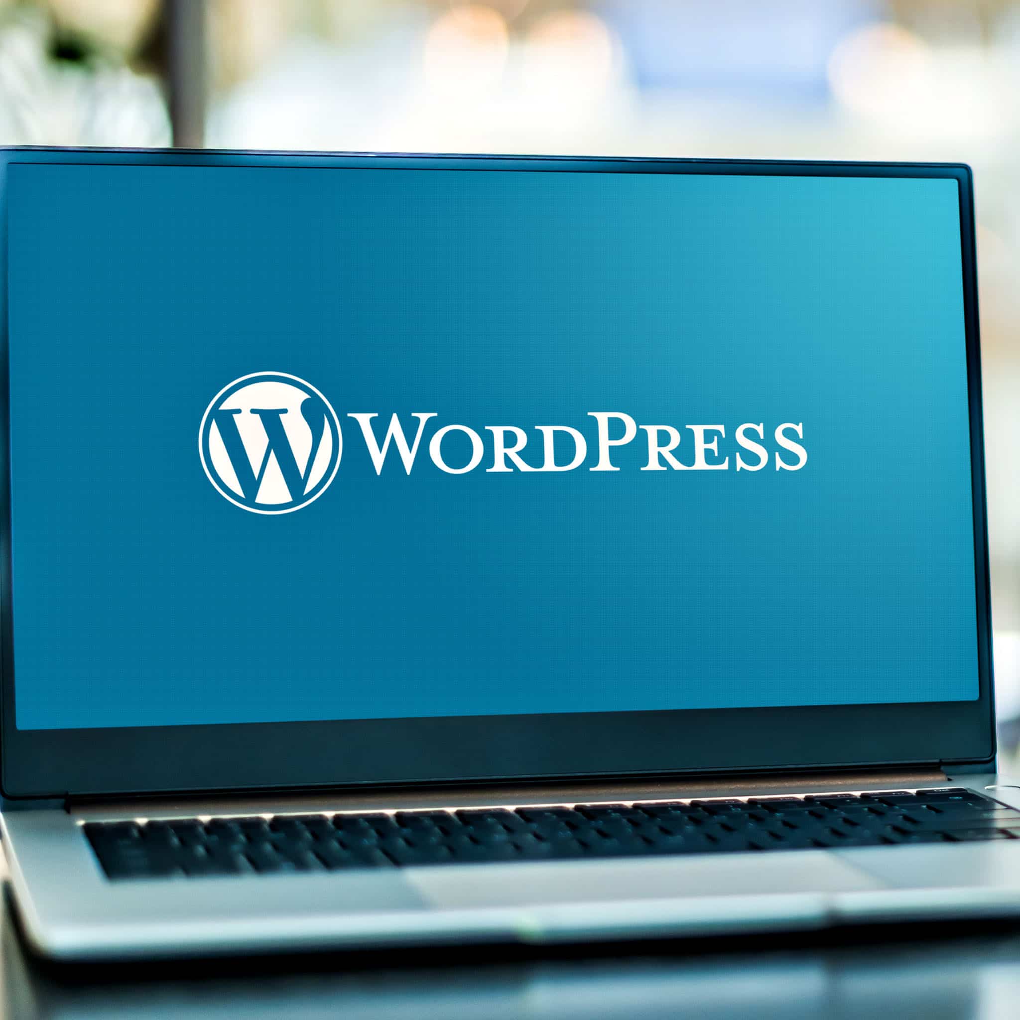 Laptop displaying WordPress logo on screen