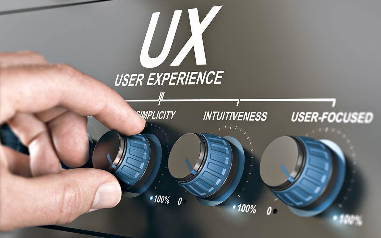 Hand adjusting user experience dials for simplicity, intuitiveness, and user-focused design