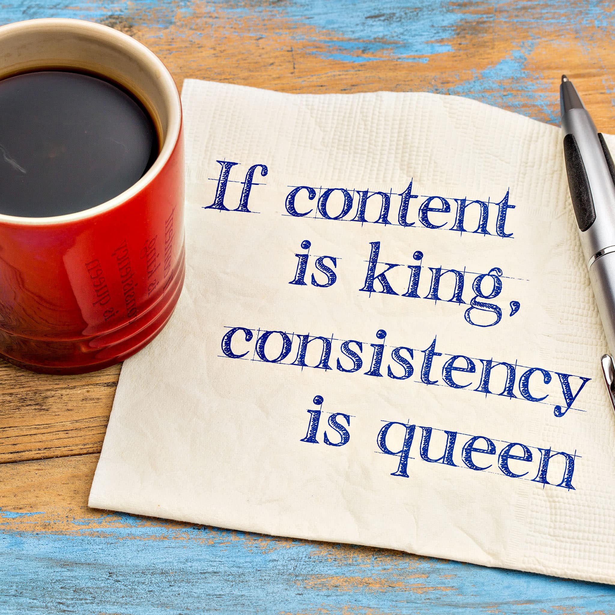 Coffee next to napkin with motivational content quote