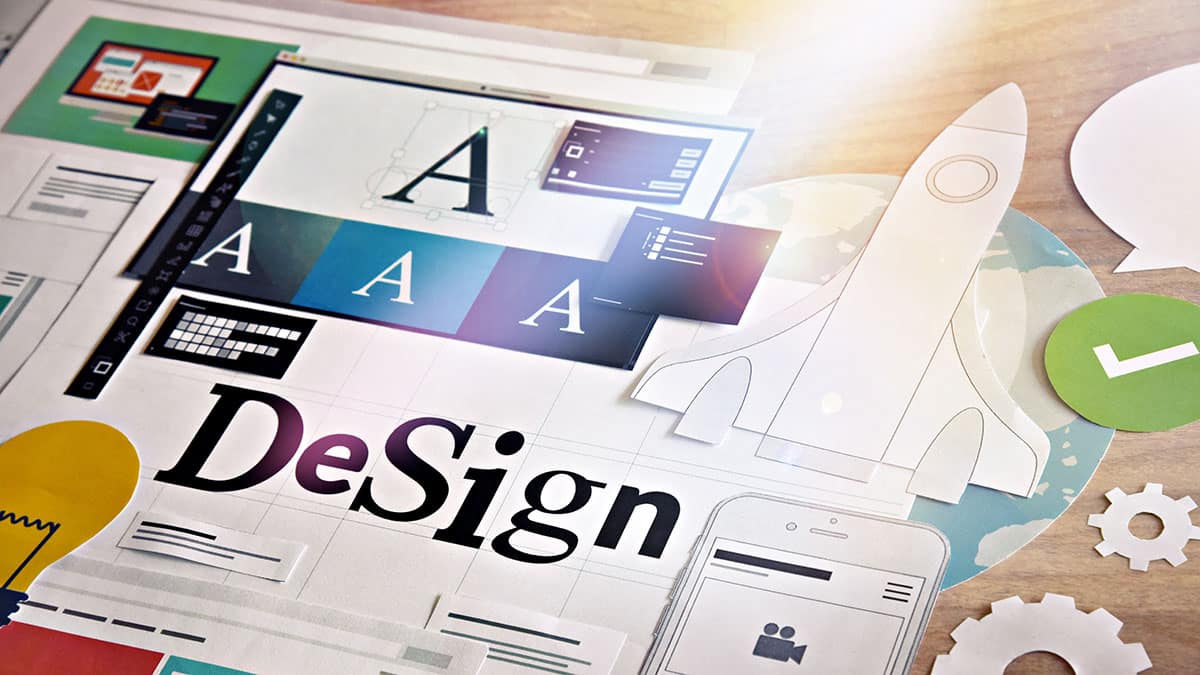 Creative design process with digital tools, fonts, and rocket illustration