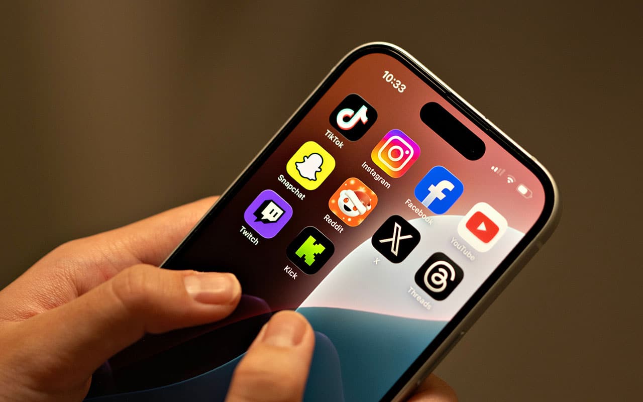 Person using smartphone with popular social media apps