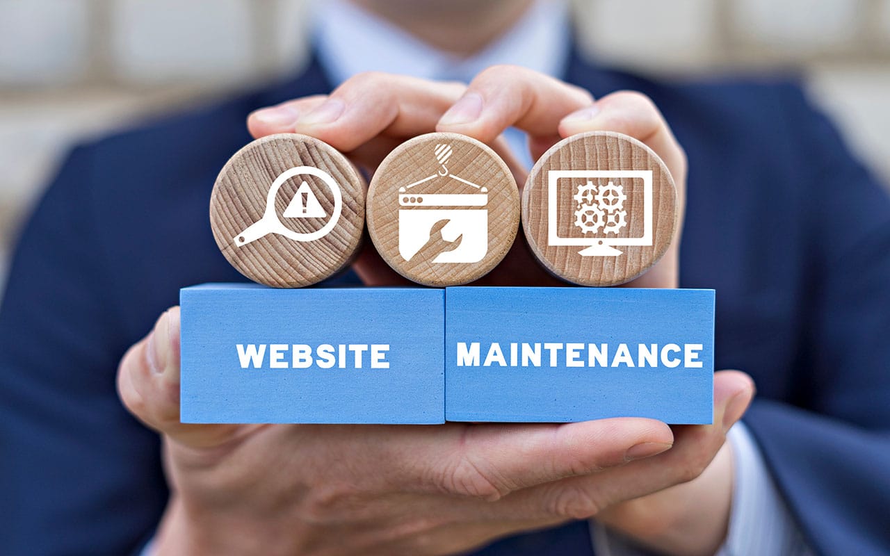 Website maintenance concept with icons on wooden blocks