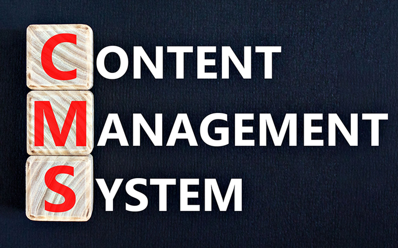 Wooden cubes spelling CMS with Content Management System text