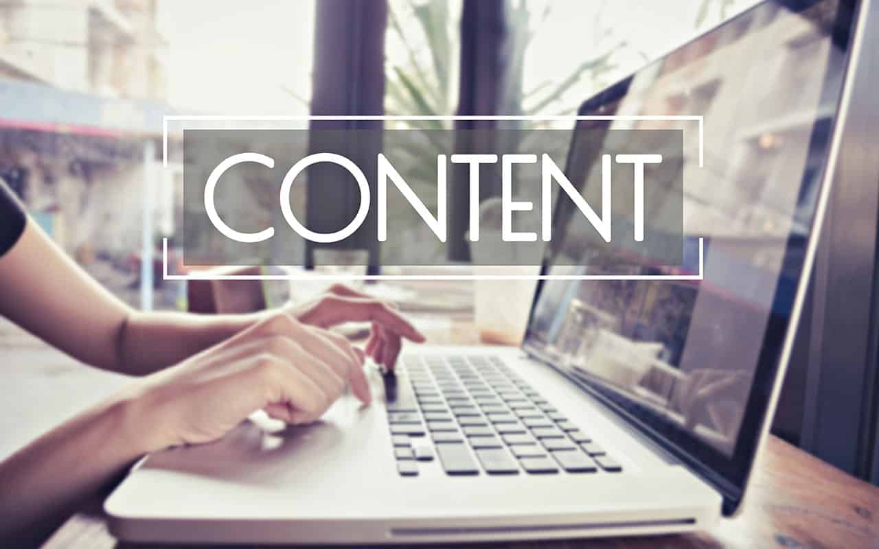 Person typing on laptop with 'CONTENT' text overlay highlighting digital communication concept